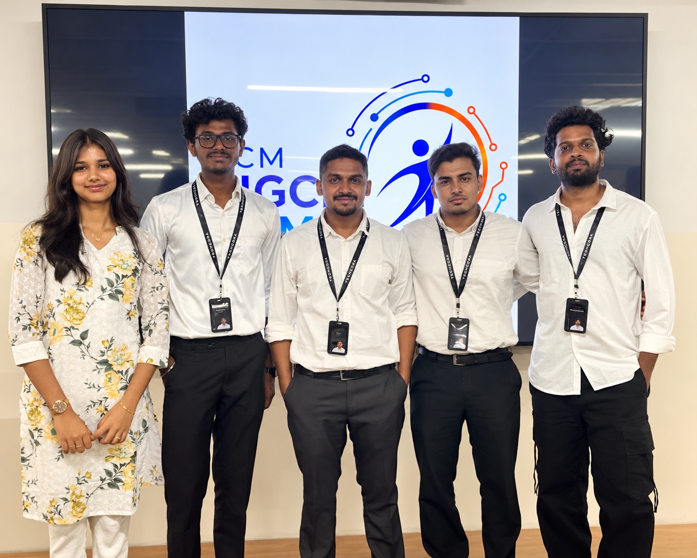 The Techcora team at DOOMSDAY 2026, standing in front of the SRM ACM SIGCHI screen